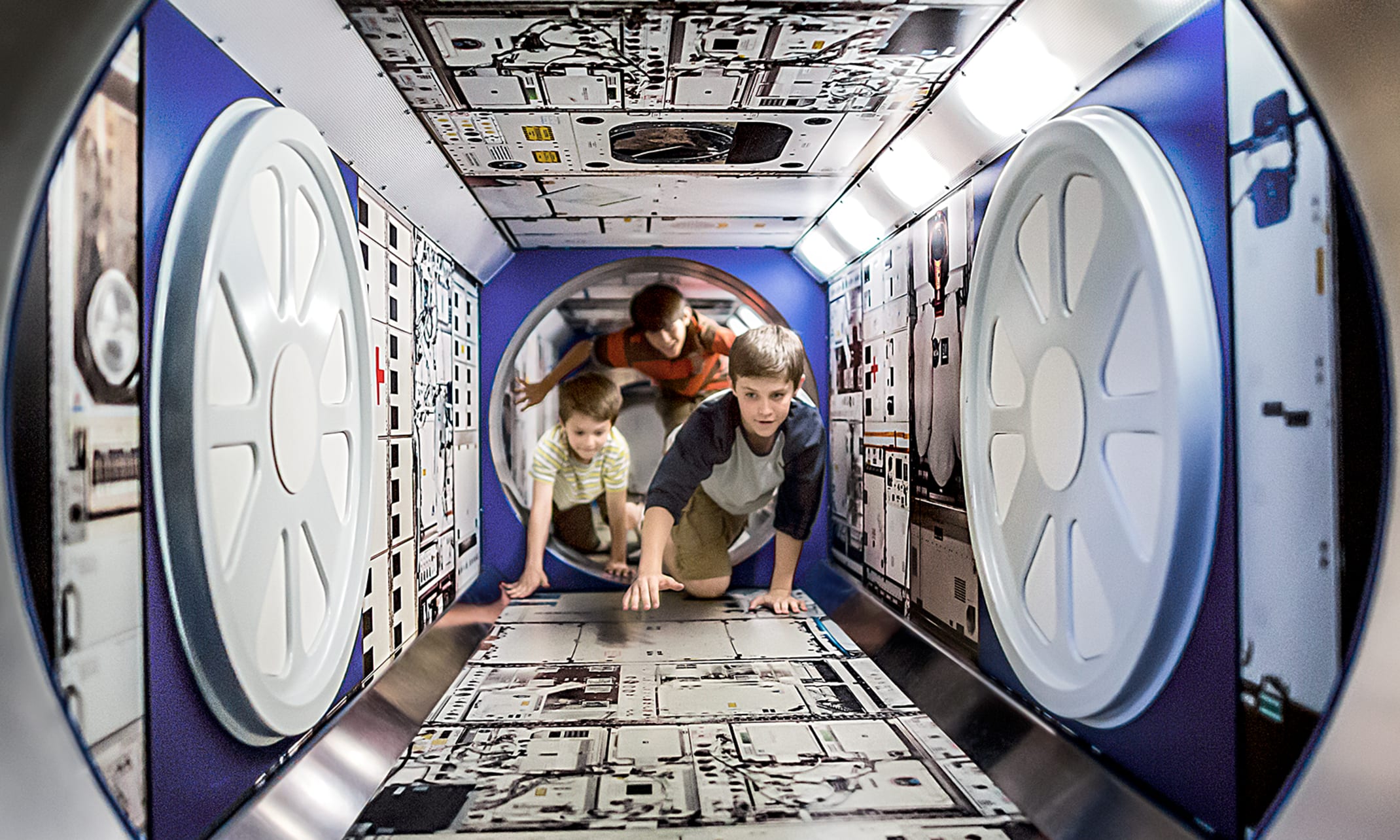 Children crawling through the ISS Tube