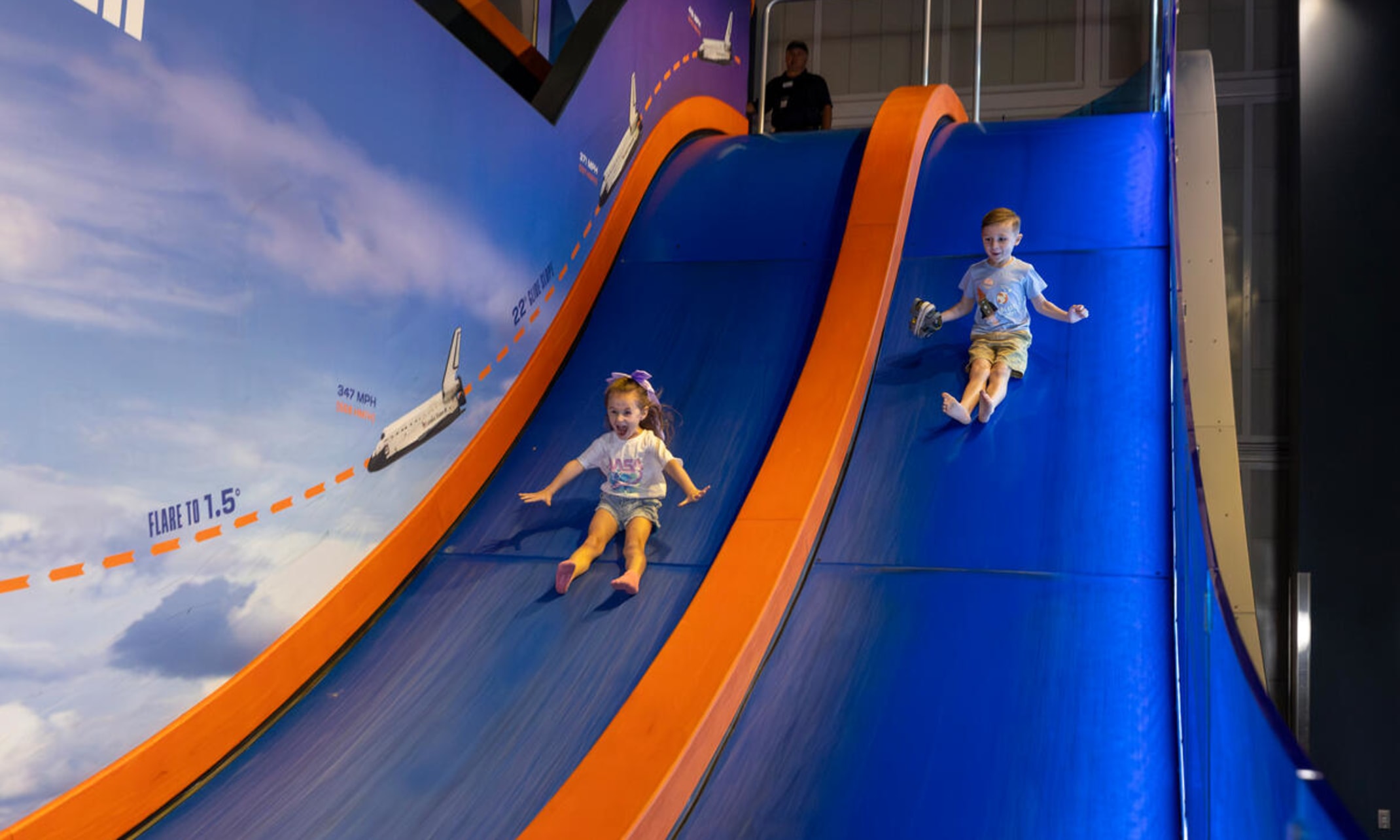 Children sliding down the re-entry slide
