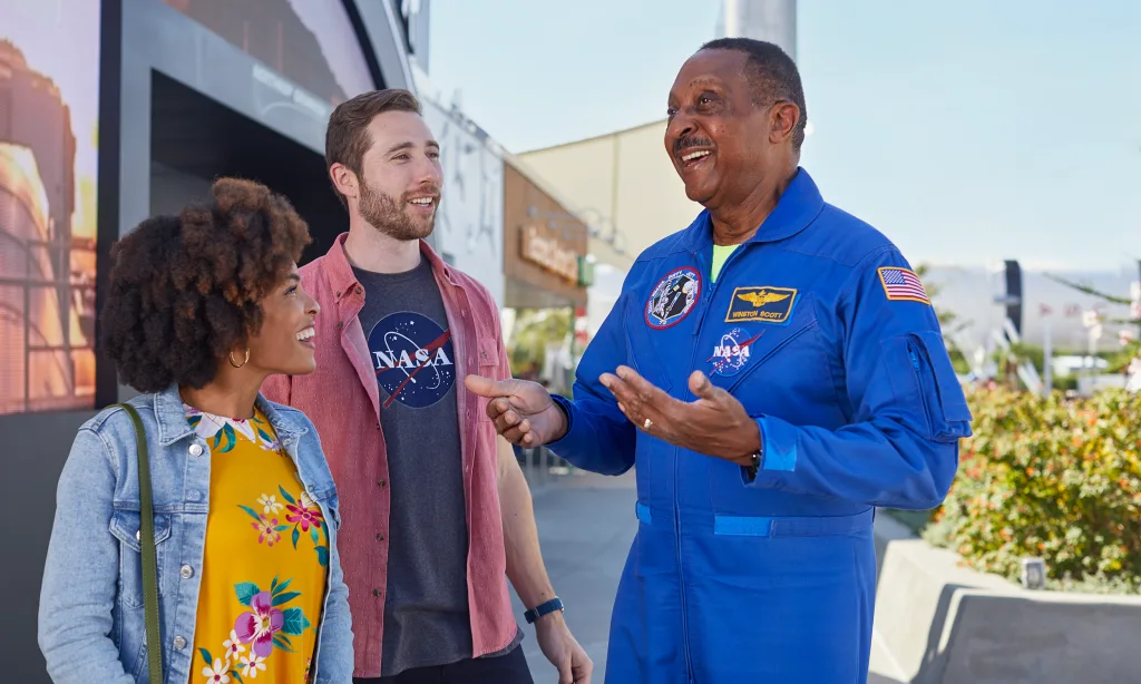 Man and woman talking to an astronaut during the astronaut encounter attraction.