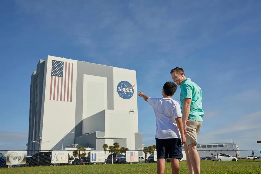 Father and son pointing to the VAB building