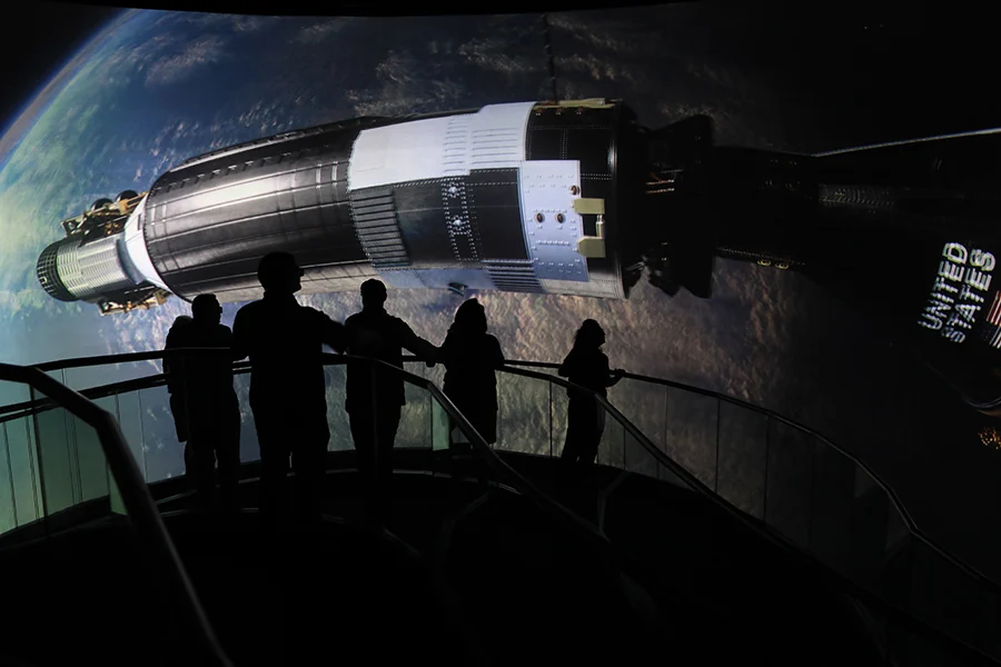 Visitors watching a video on a screen