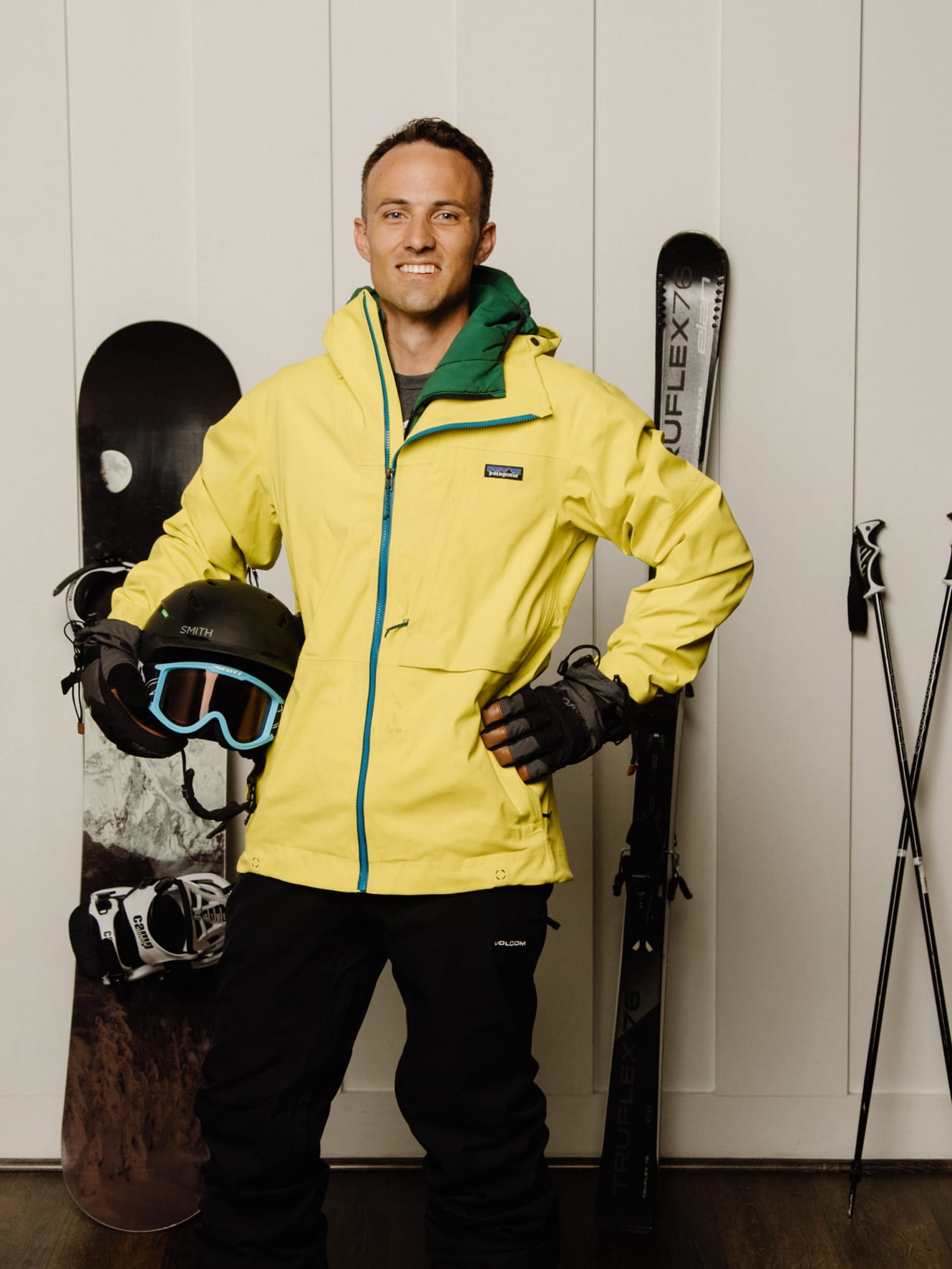 Kent wearing snow clothes with skis and a snowboard