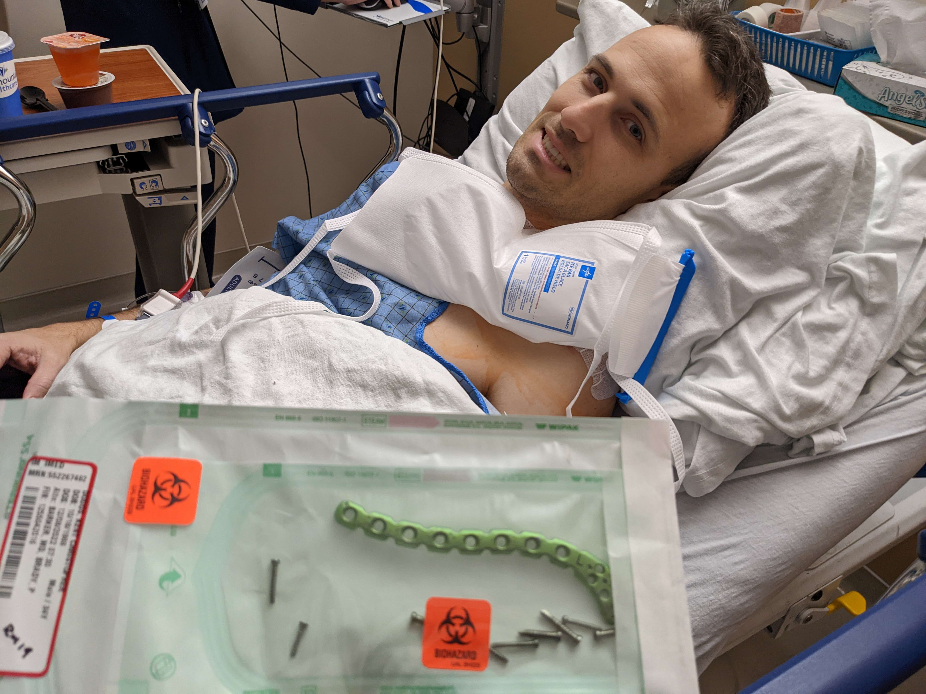 Kent in a hospital bed with a green clavicle plate and nine screws