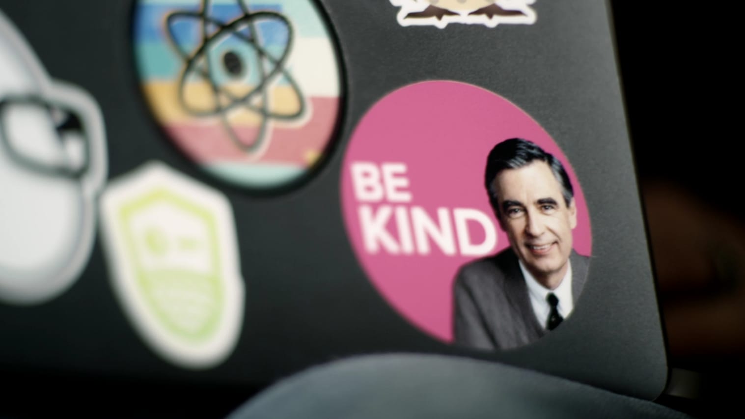 Laptop stickers with one that has a photo of Mr. Rogers and says "Be Kind"