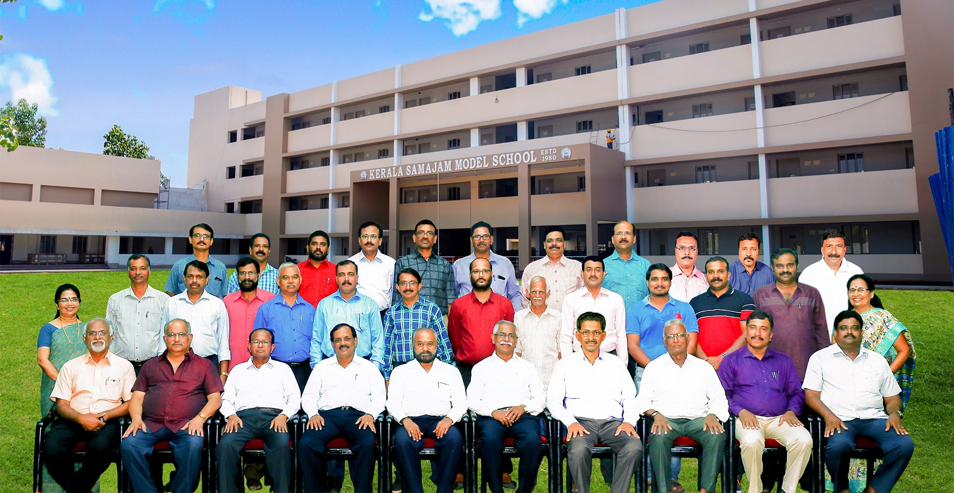 Members of the Board of Trustees and the Executive Committee of Kerala Samajam, photographed in front of Kerala Samajam Model School