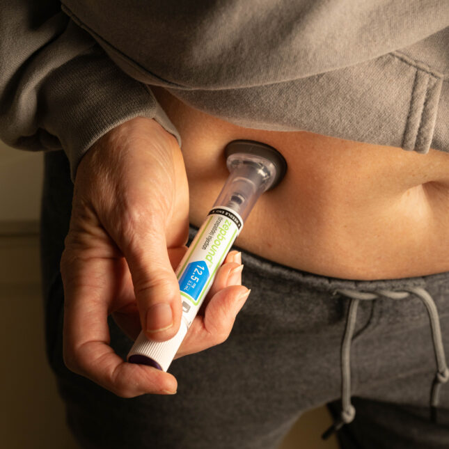 A clinician holding a blood sample for lab testing