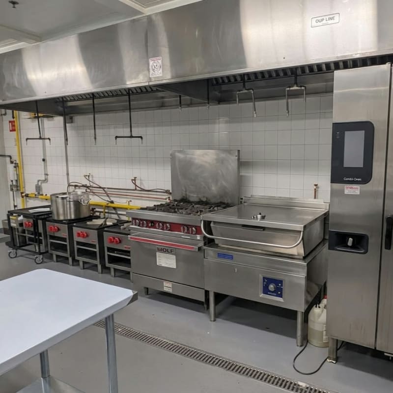 Full MiFoodStudio cook line straight-on under the exhaust hood