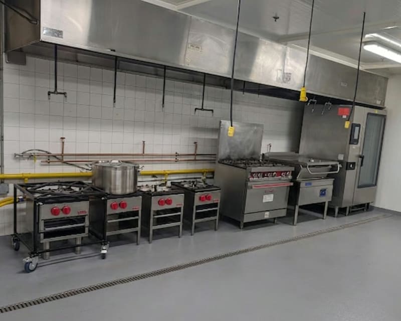 Wide view of the MiFoodStudio cook line including stock pots