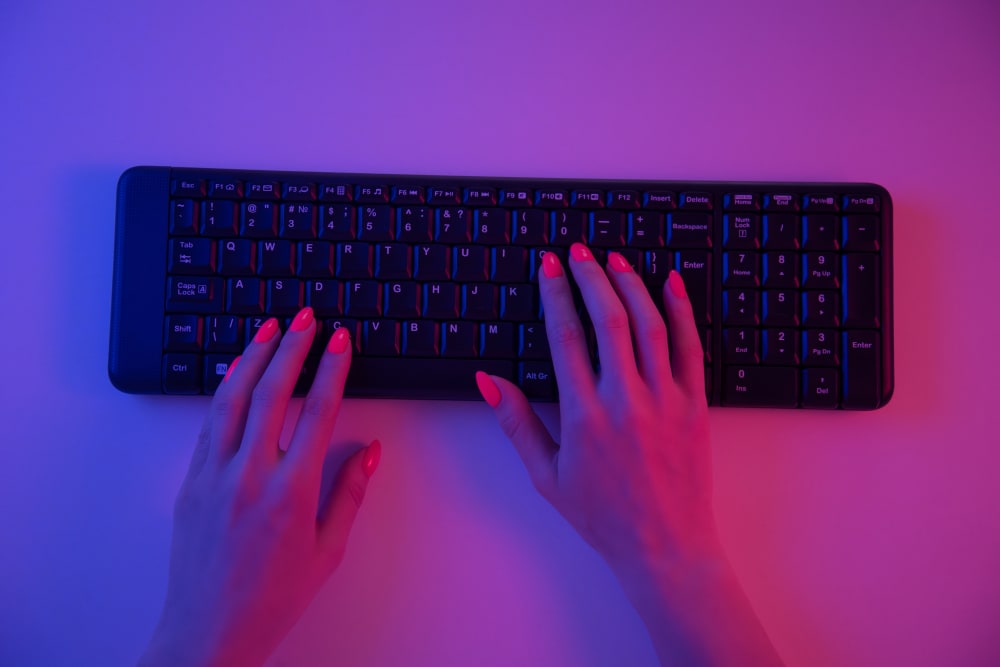 Woman Typing on a Wireless Keyboard