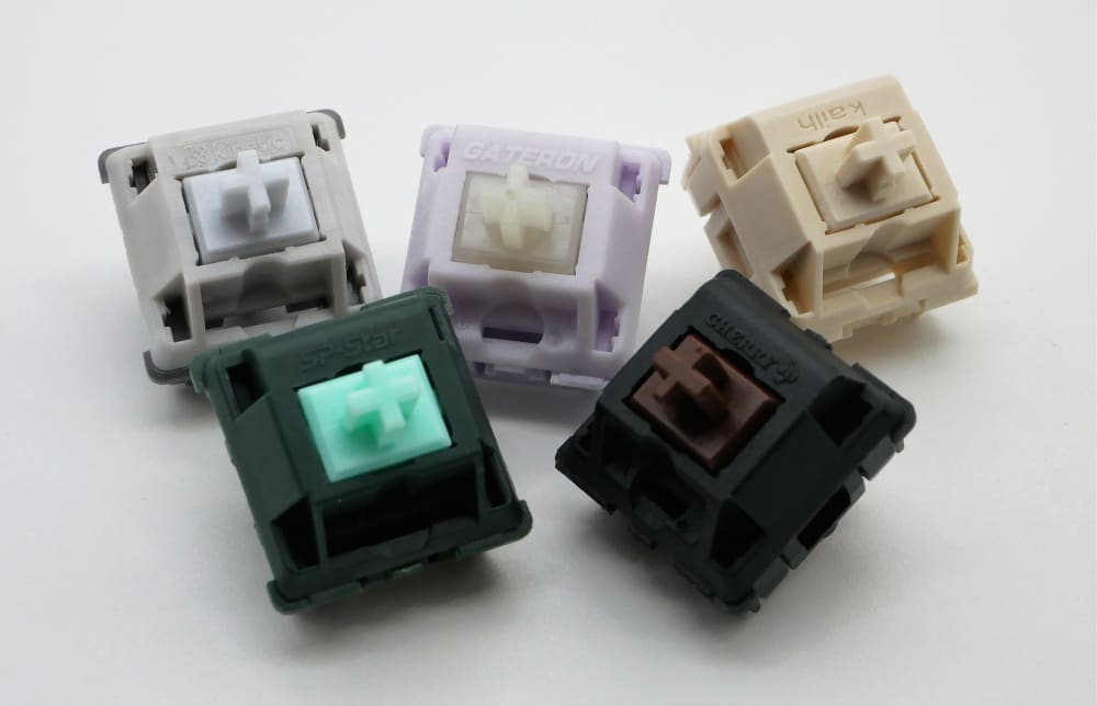 Factory unlubed switches. (L-R, Top-Bot: Kinetic Labs Husky, Kinetic Labs Husky, Novelkeys Cream, SP Star Sacramento, and Cherry MX Brown)