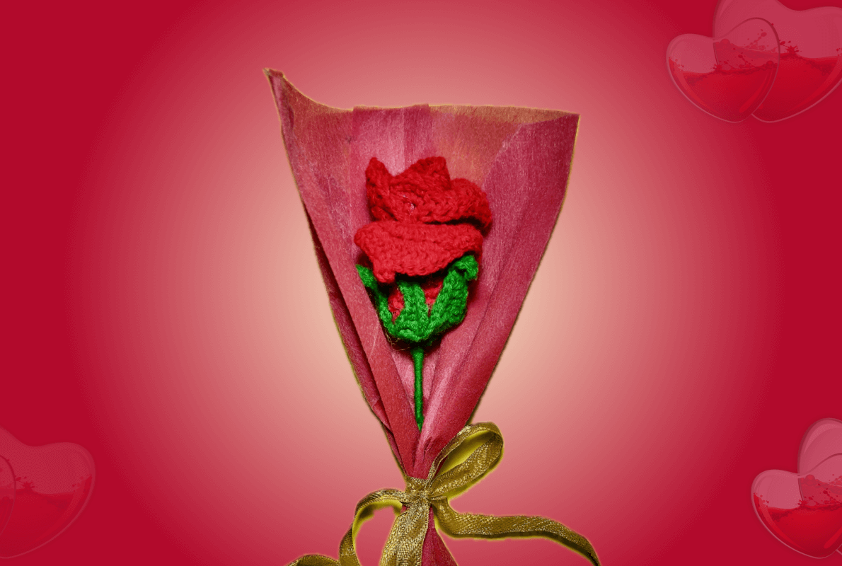 Handmade crochet red rose bouquet wrapped in elegant red paper with a golden ribbon, designed as a perfect Valentine’s Day gift.