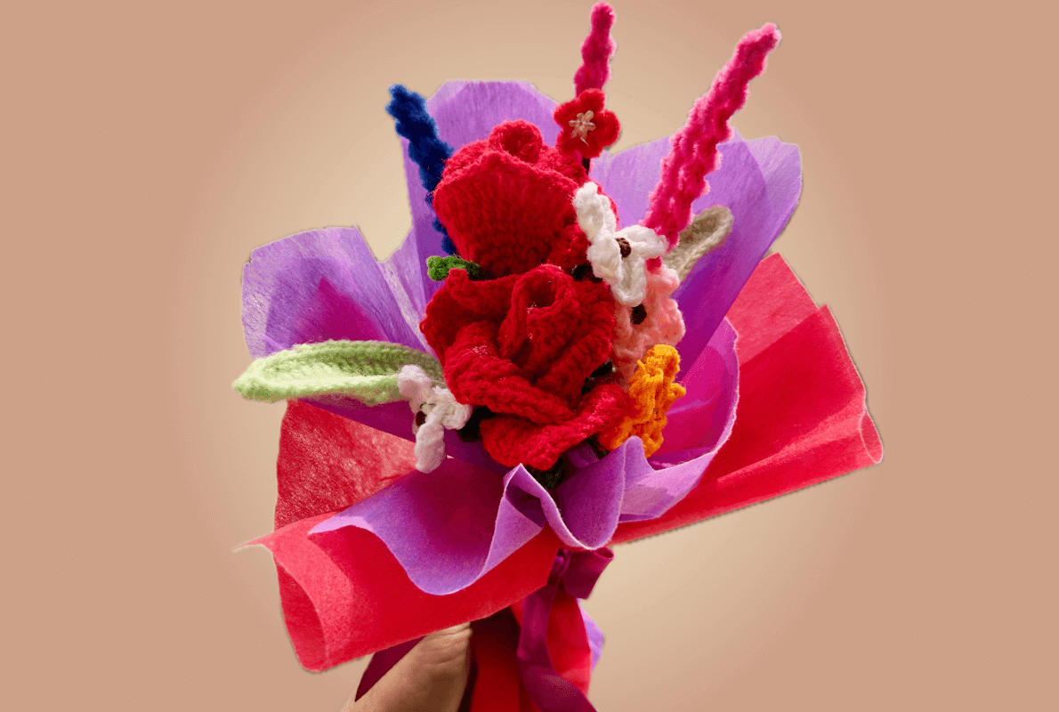 Forever Bouquet – A luxurious handmade crochet bouquet featuring vibrant red roses, delicate white, pink, and yellow flowers, wrapped in elegant purple and red paper with a satin ribbon, perfect for gifting and special occasions.