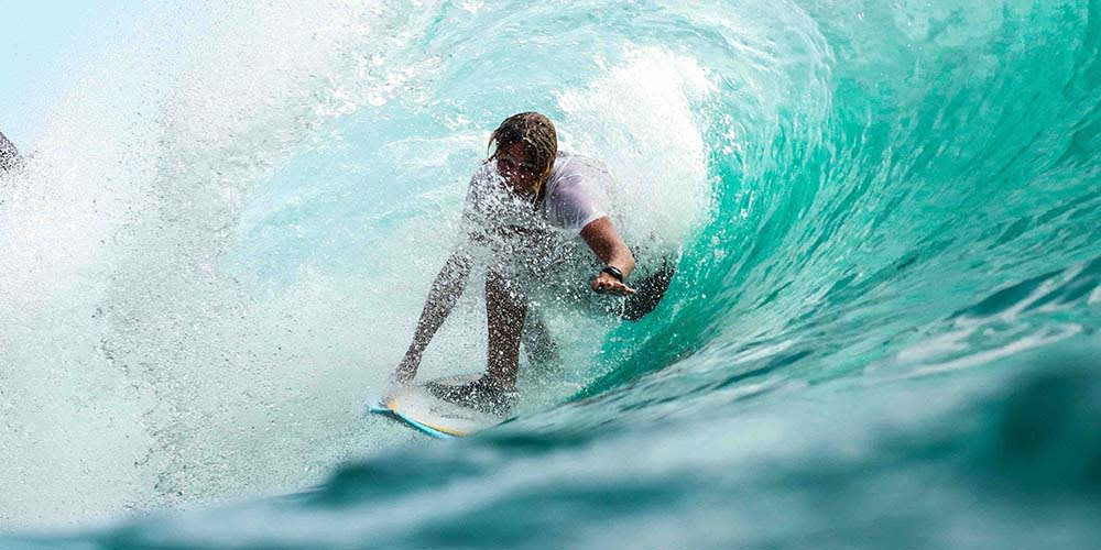 man surfing inside crest of wave
