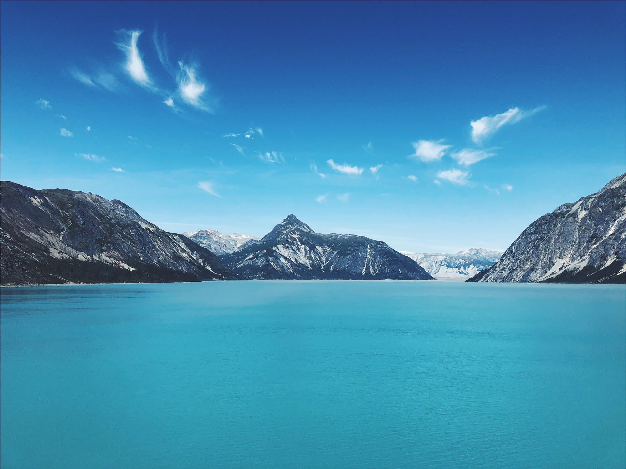 Beautiful blue nature shot of a mountain and a lake.