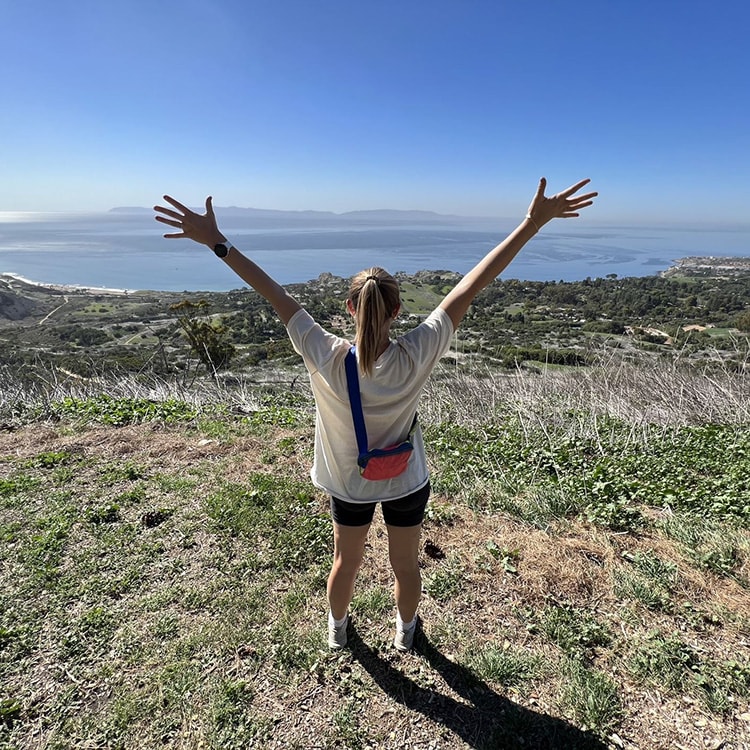 woman with arms raised triumphantly in the air