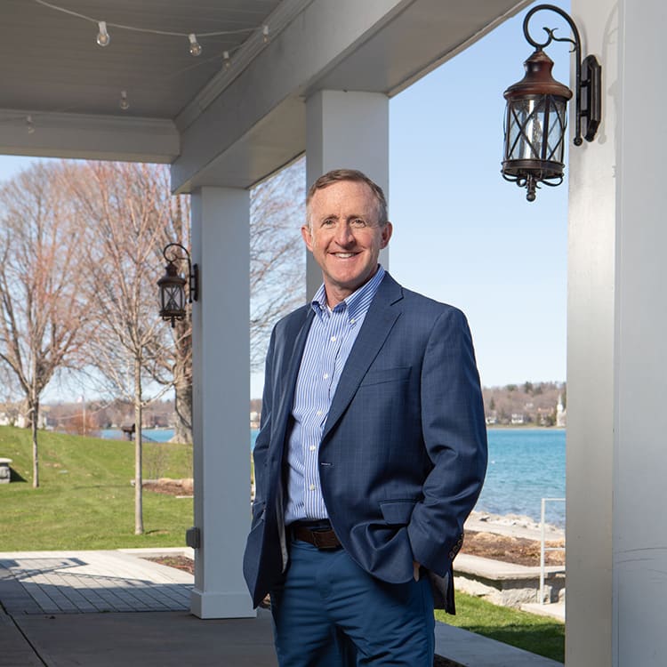 CEO jerry morrissey under an awning near a lake