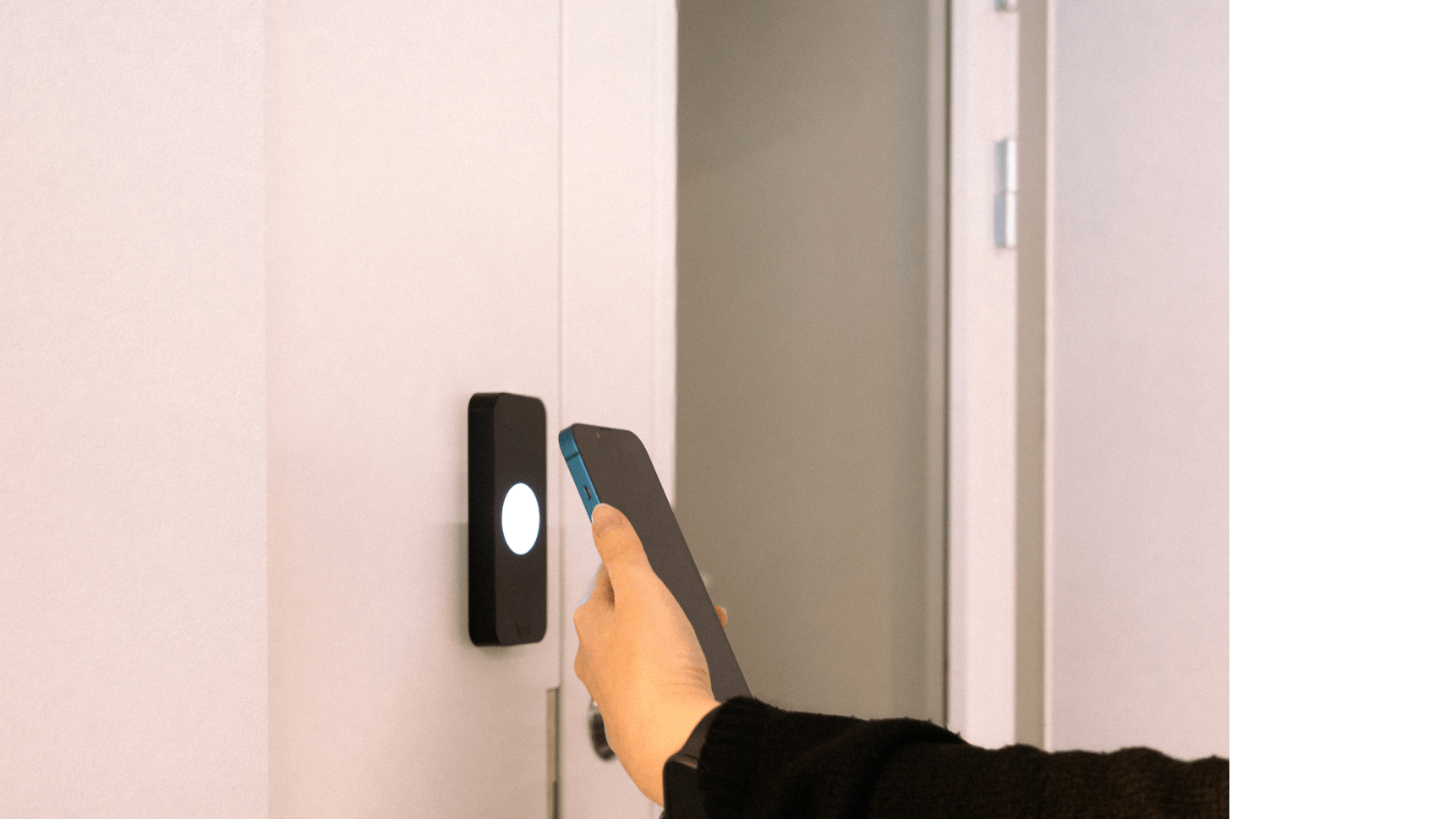 person using mobile keyless entry method in an office: unlocking a door by taping a phone against the Kisi access reader