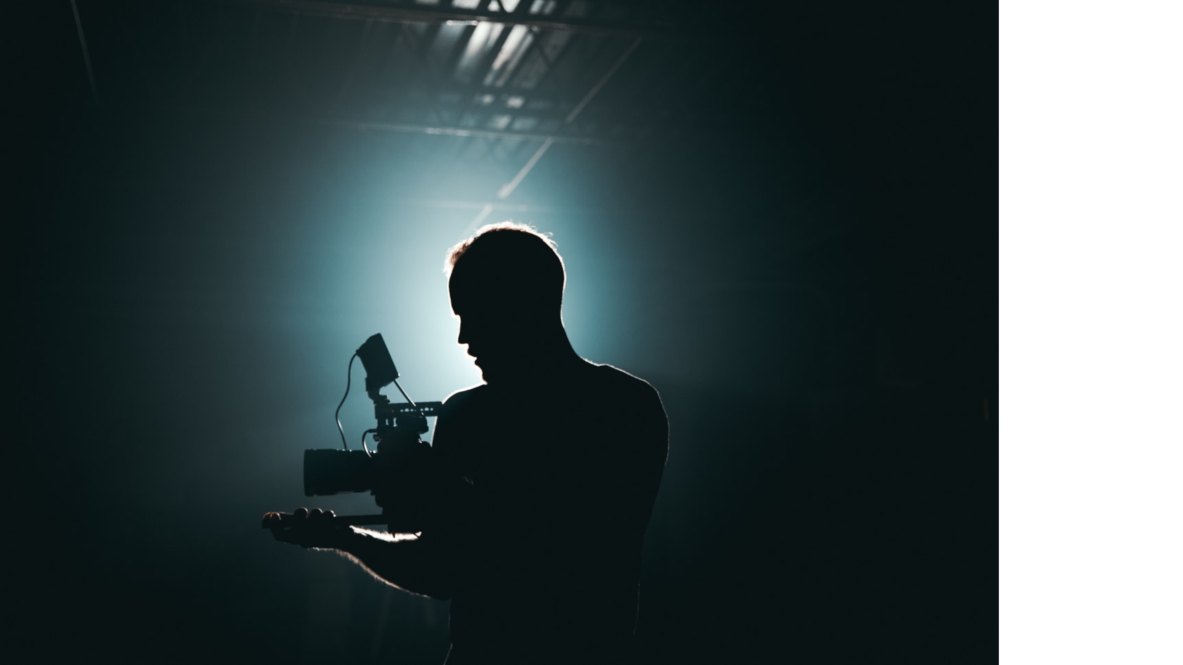 An image of a cameraman in the spotlight