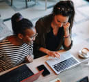 Two women at a coworking space talking