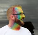 Person with rainbow colours on their face