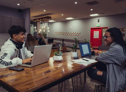 people collaborating on laptops in a coworking space