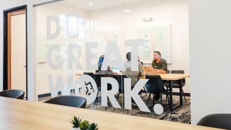 An image showing working space at FoundrSpace where people collaborate with a motivating quote