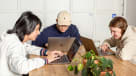 A picture of Stuart, a Backend Developer Intern at Kisi collaborating with two Kisi employees in the Stockholm office