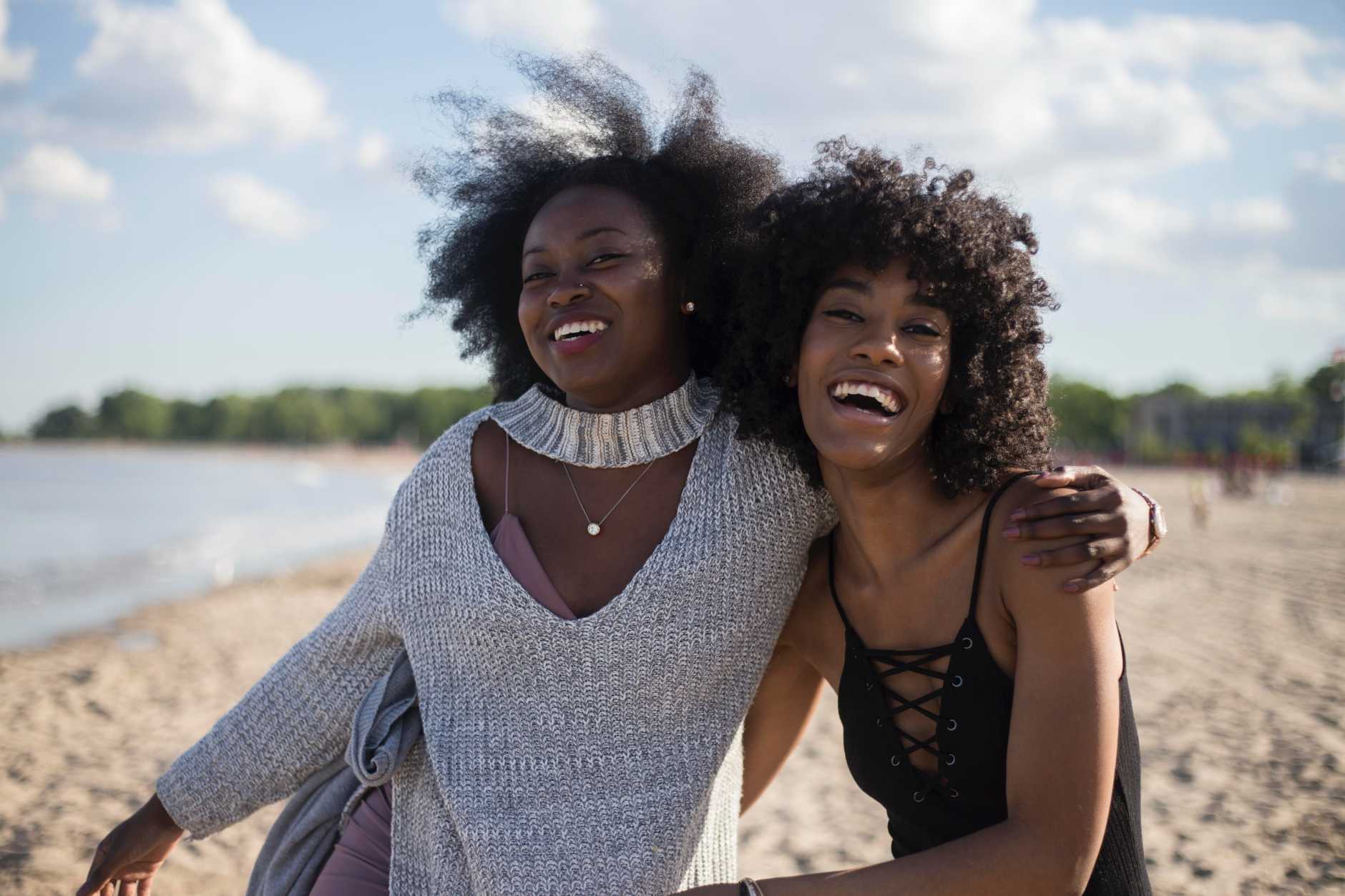 an image of two women having a good time at the beach 