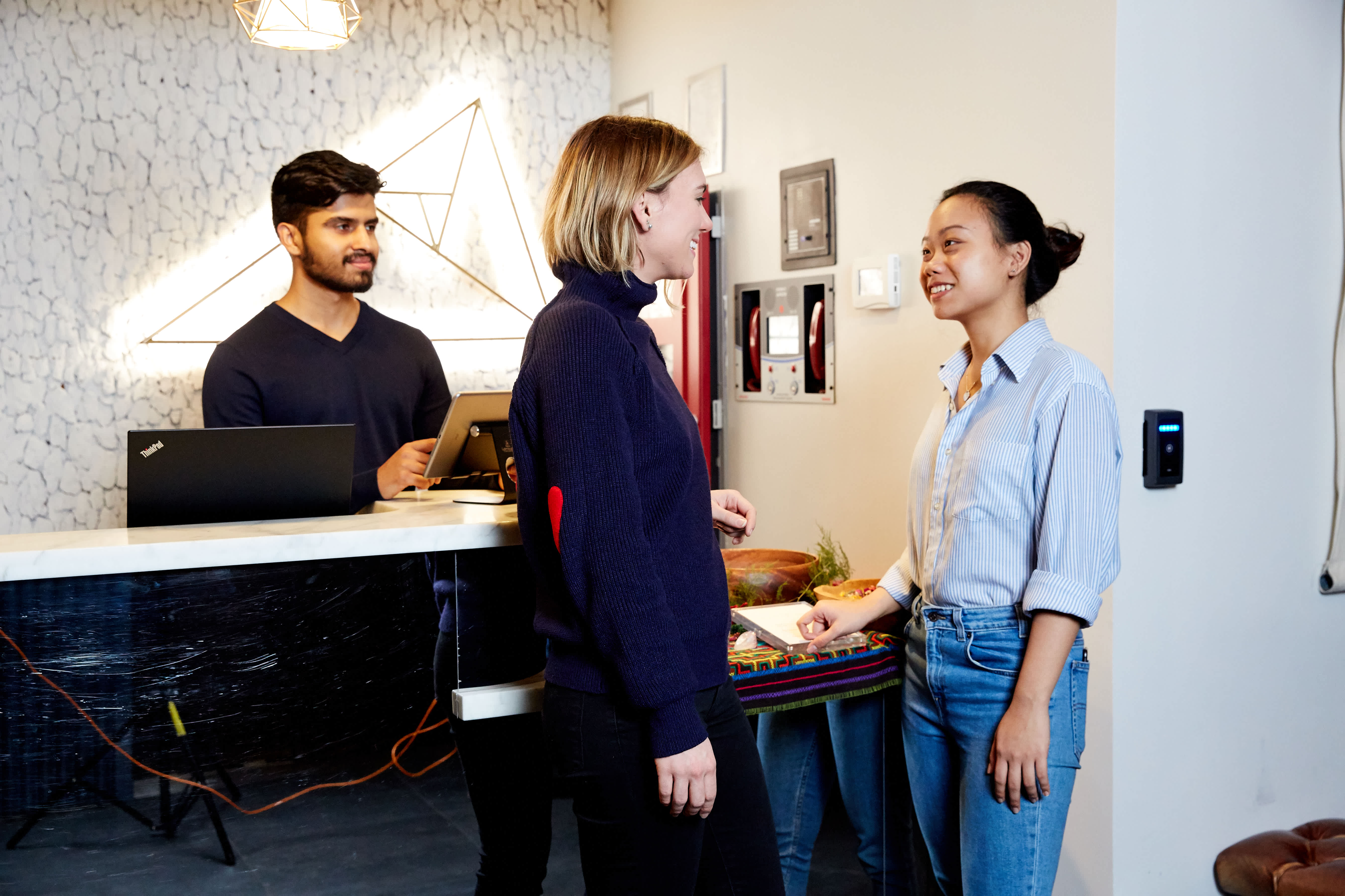 coworkers meeting at The Assemblage in front of Kisi reader 