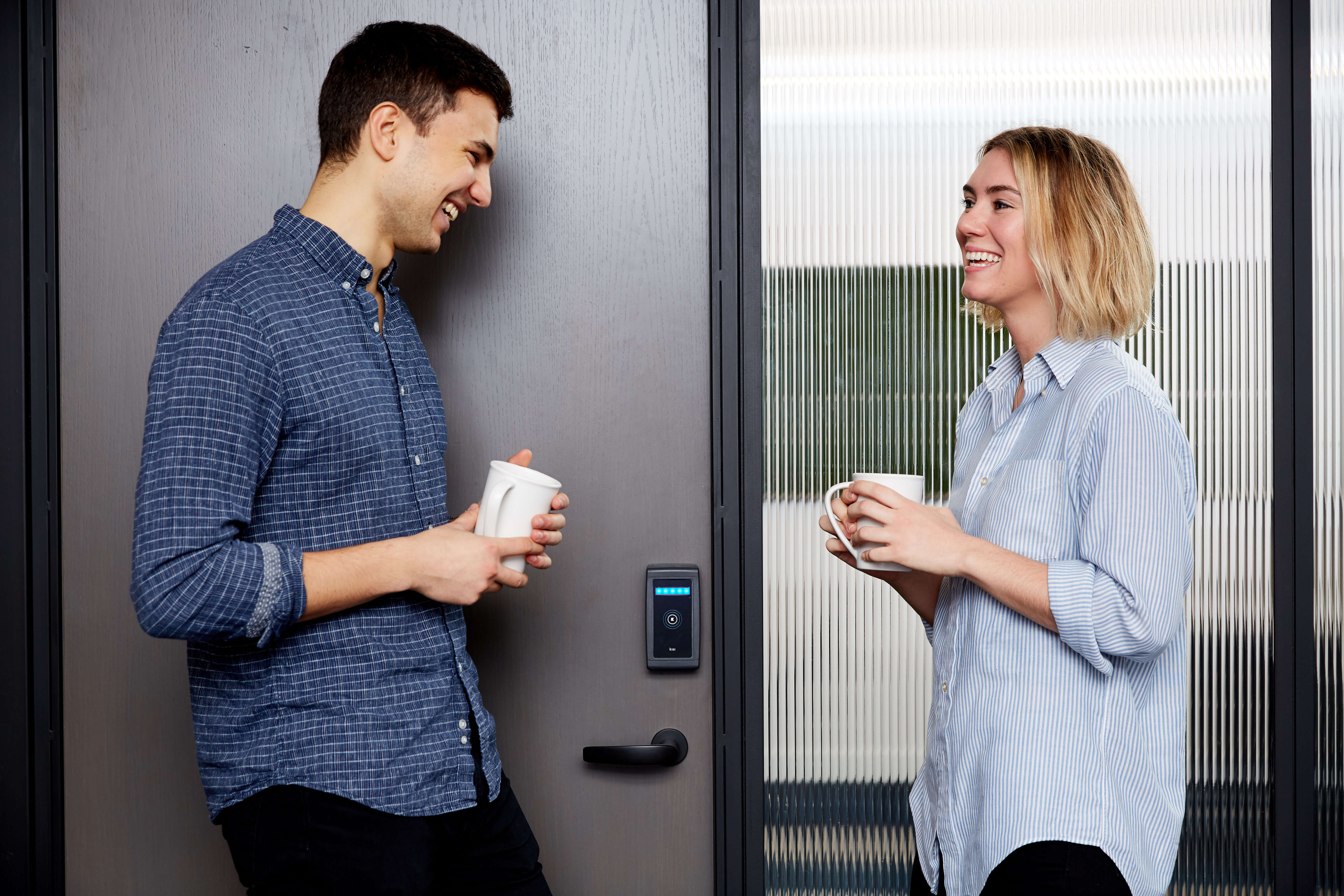 coworkers laughing in front of conference at The Assemblage
