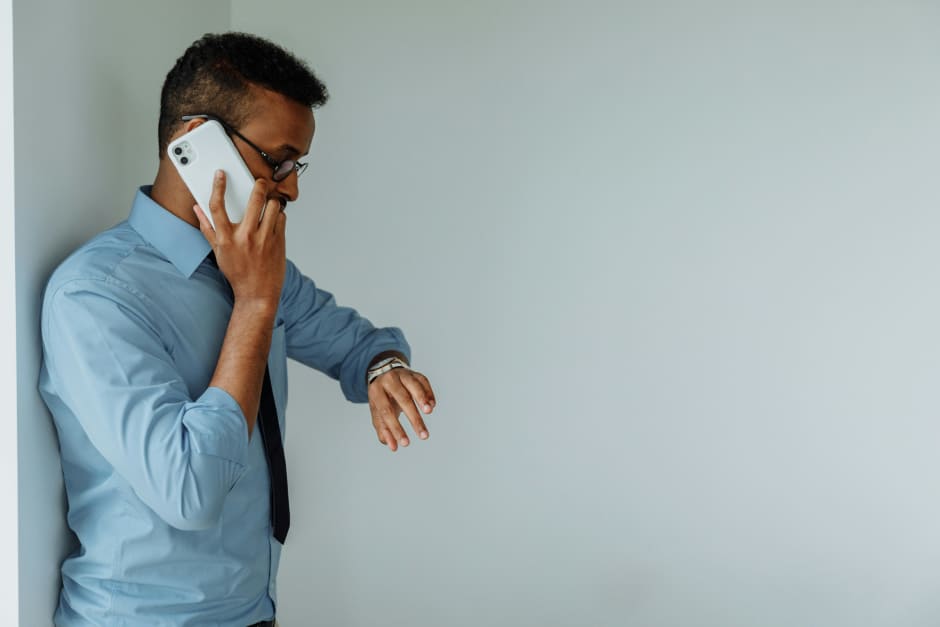 employee running late asking a work buddy to clock them in