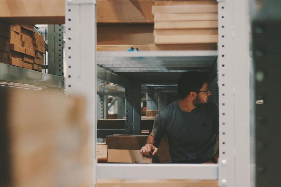 a person looking behind his back in a storage area