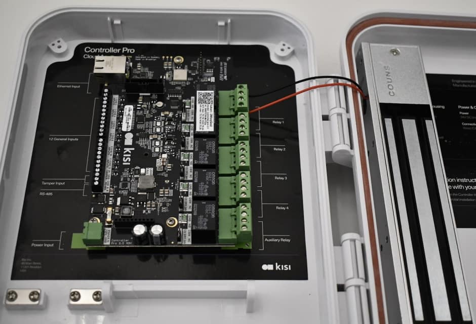 An image showing a Kisi access controller wired to a magnetic lock