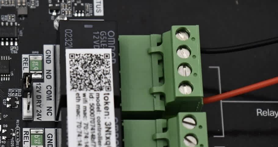 A close up of a Kisi access controller wired to a magnetic lock