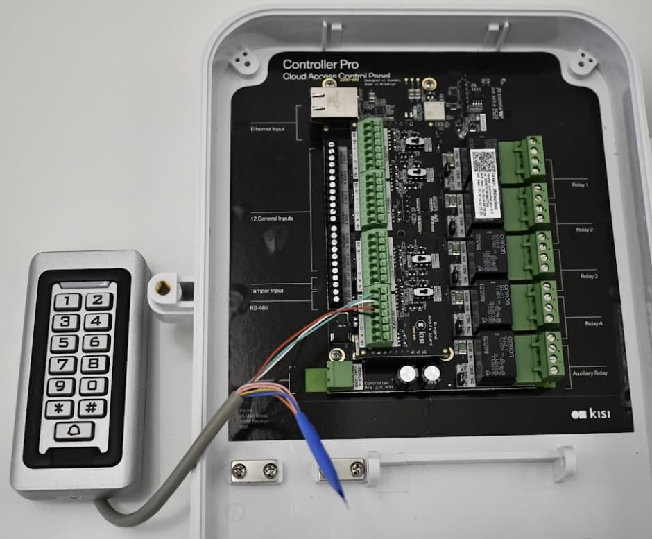 An image showing a Kisi controller wired to legacy keypad access reader