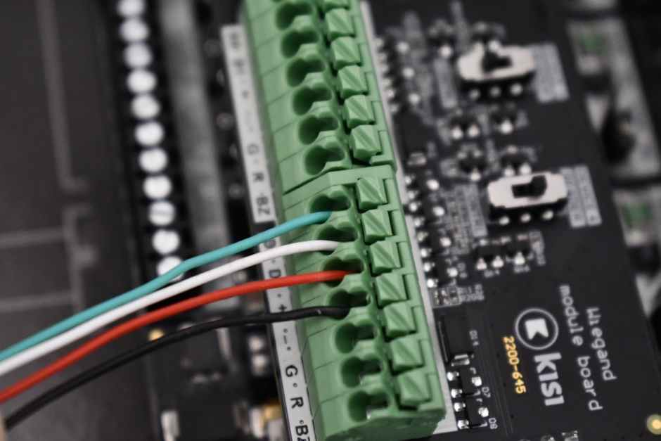 A close up showing a Kisi Wiegand board wired to legacy keypad access reader