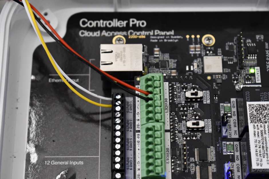 a close up of the wiring of a no-touch exit with the Kisi access control panel