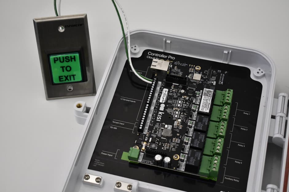 an image showing a push to exit button wired to the Kisi access control panel