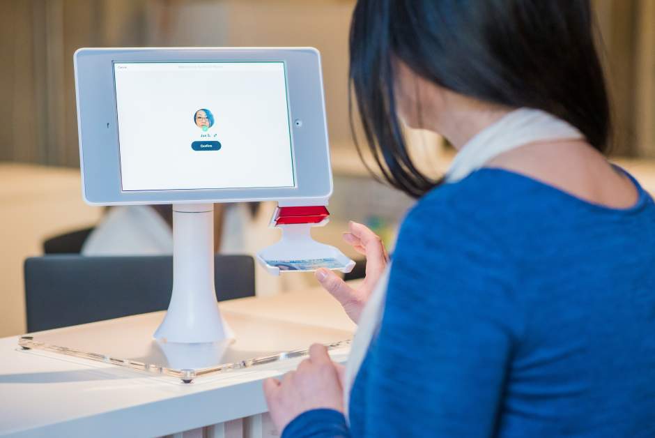 person checkin in at a visitor management kiosk