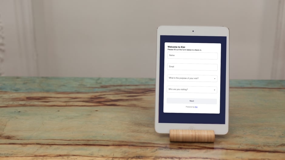 Ipad stand with a visitor management screen on a front desk