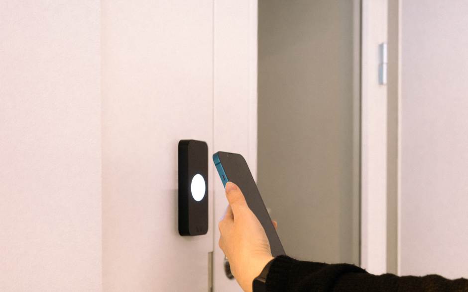 tenant unlocking a door with phone for seamless property experience