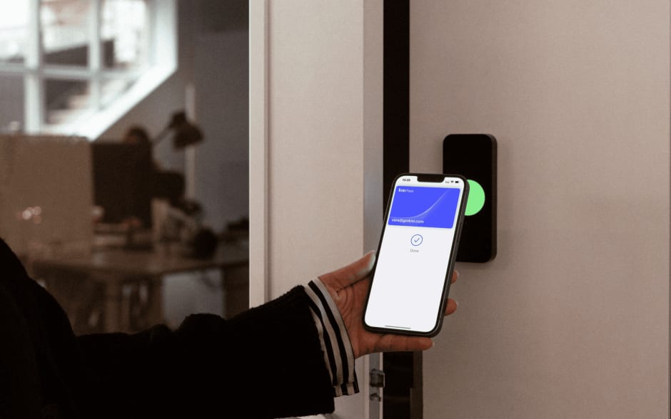 Person unlocking a door with employee badge in Apple Wallet
