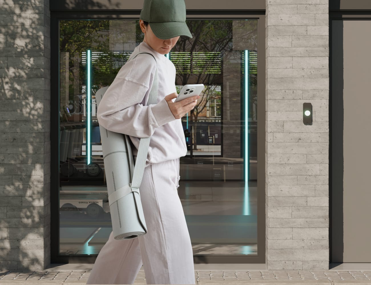 An image of a girl with a yoga mat unlocking with her phone