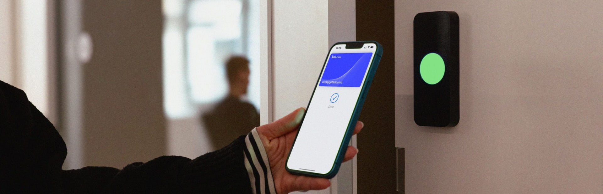 A person has unlocked a door with their employee badge in Apple Wallet with the help of a Kisi access control reader