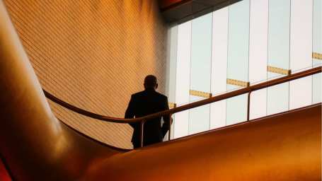 An image showing a man standing in a financial institution