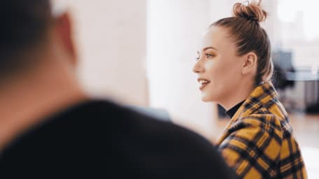 An image showing woman interacting in an office environment 