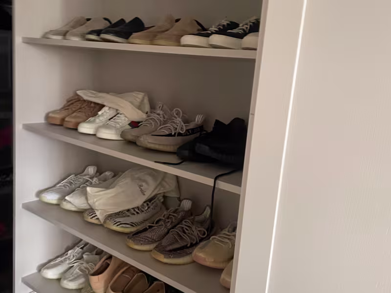 custom shoe storage built into a fitted wardrobe system