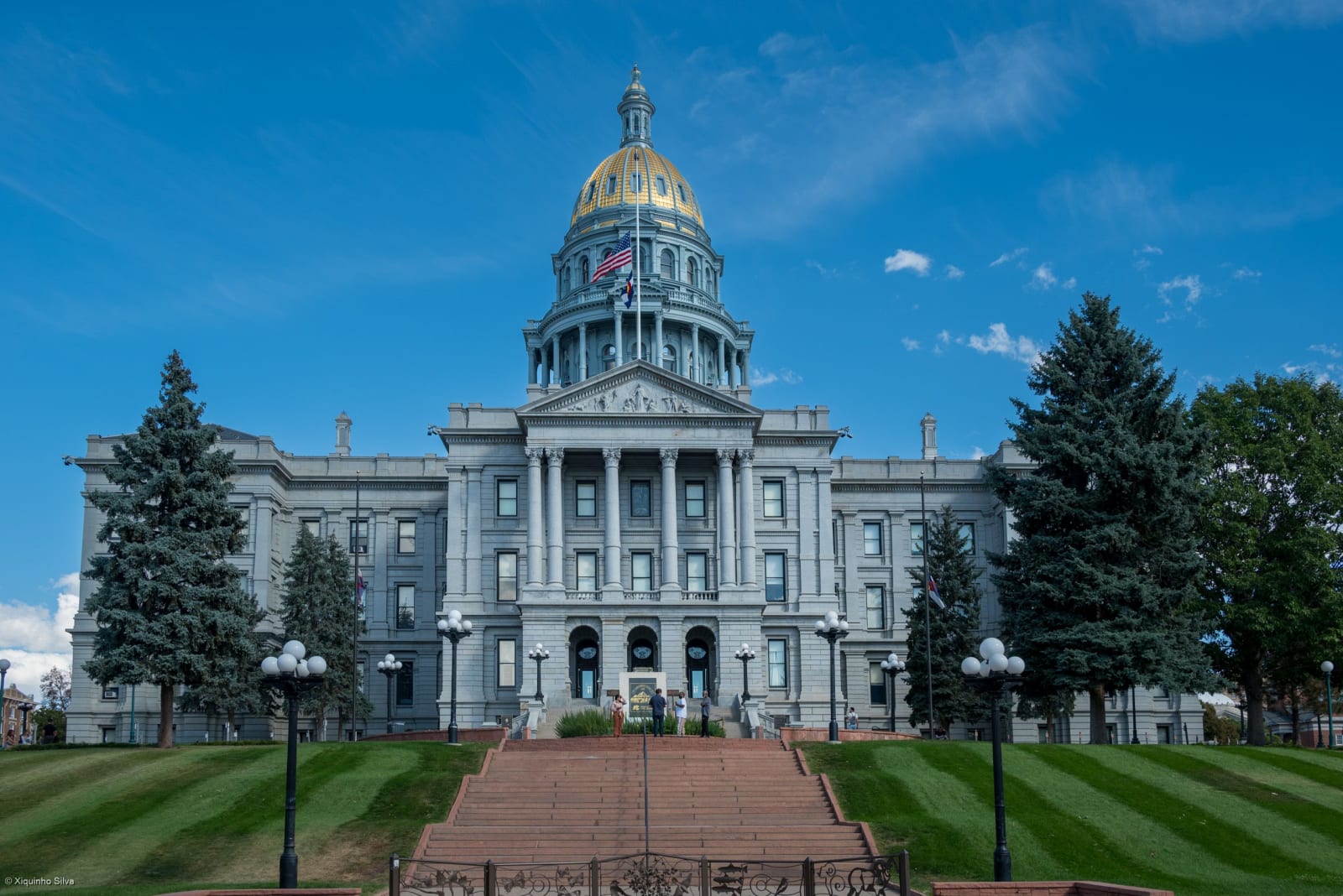 The Colorado State Capitol and its gold dome above the west lawn and steps