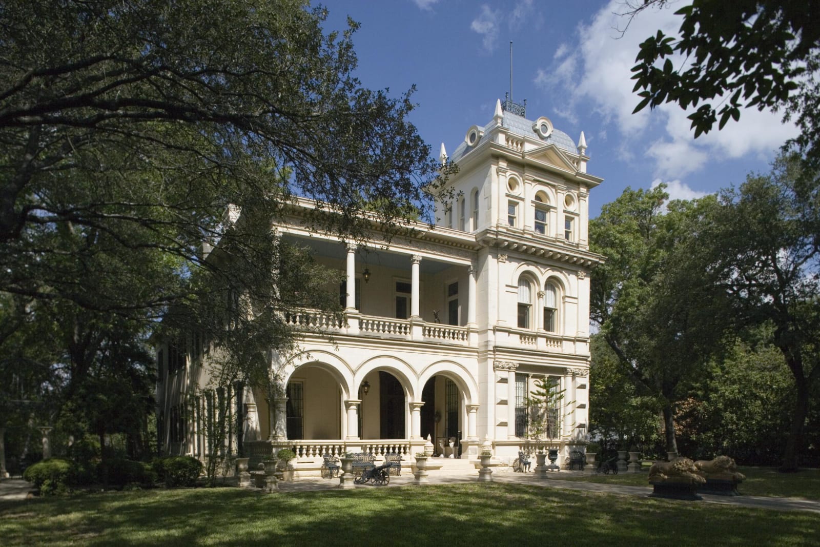 Villa Finale, a white Italianate mansion with arched porches and a tower, among trees in the King William district of San Antonio.