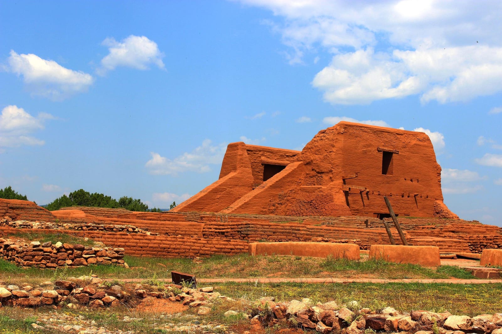 The adobe walls of the mission church at Pecos rising above the stone foundations of the pueblo